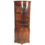 A good quality flame mahogany 19th century revival bow fronted display corner cabinet. The base with