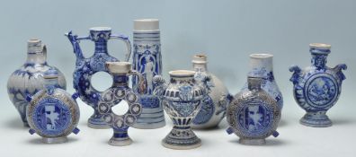 A collection of 20th Century German blue and grey stoneware ballamine style vessels to include