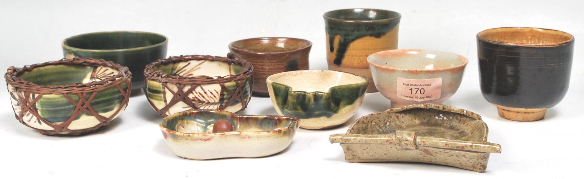 A collection of Chinese cream and green glaze finger bowls, rice bowls and saki cups. To include