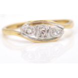 A yellow gold 3 diamond crossover ring. Size 7.N. Weighs 2.1g.