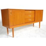 A vintage retro 20th Century teak veneered sideboard credenza having a central bank of four