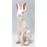 A vintage retro ceramic pottery figure in the form of a hare having a white crackle glazed finish