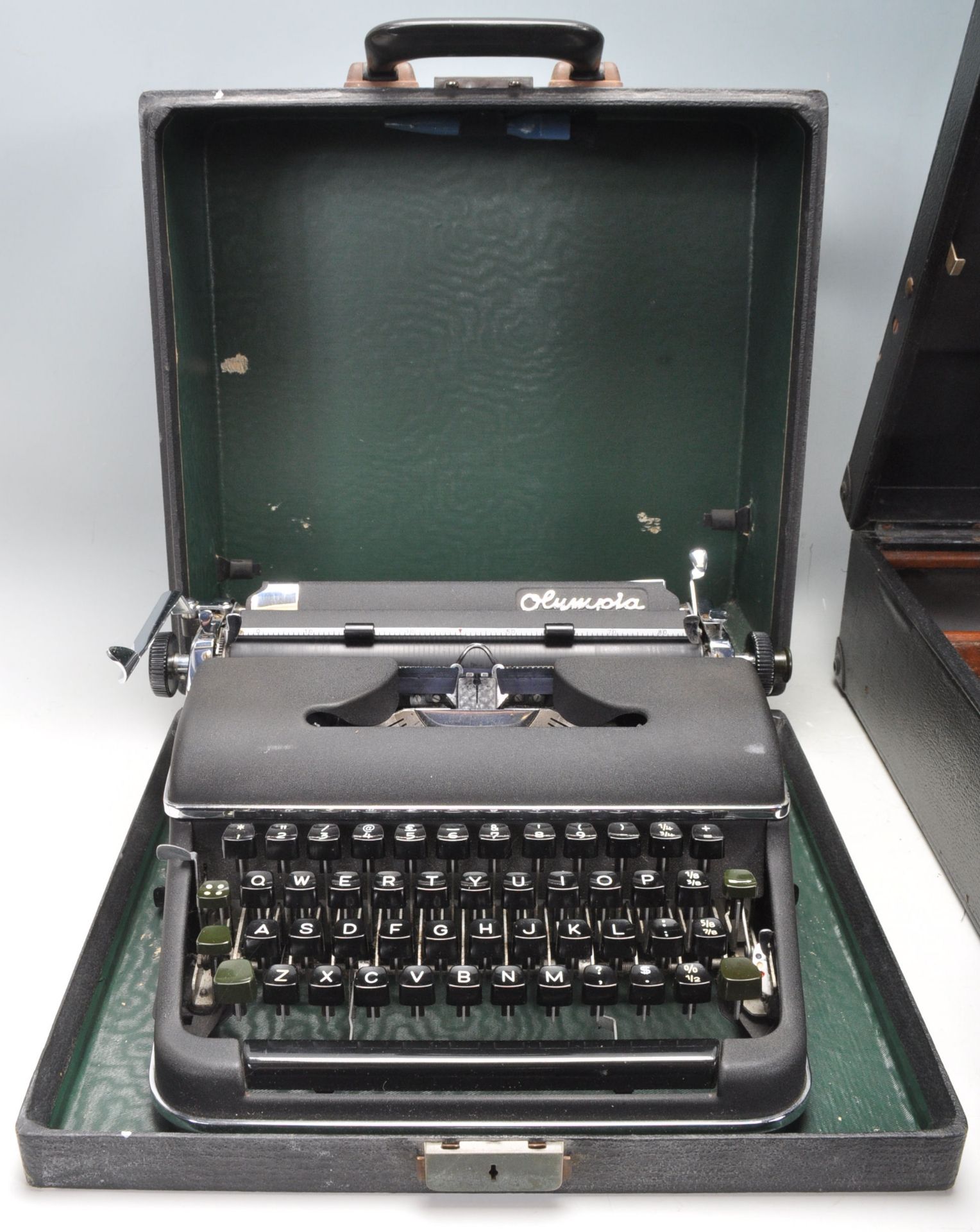 A vintage 20th Century Olympia typewriter having a black matte ebonised metal body with black typing - Bild 2 aus 7