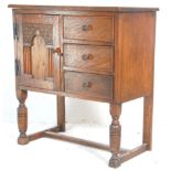 A 1930's early 20th Century oak bed side cupboard having a carved brick arch design panel to the