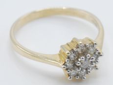 A 9ct gold ladies ring set with a cluster of nine