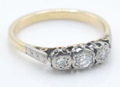 A vintage yellow gold three stone diamond ring hav