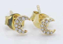 A pair of 18ct gold stud earrings having crescent