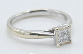 A 9ct white gold ladies ring set with four square