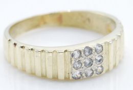 A yellow gold ring set with nine round cut diamond