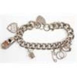 A thick link silver chain charm bracelet adorned w