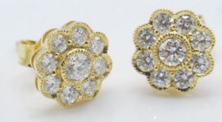 A pair of 18ct gold stud earrings having flower he