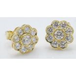 A pair of 18ct gold stud earrings having flower he