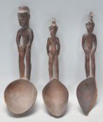 A group of three carved wooden African tribal spoo