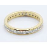 An 18ct gold ring set with a round cut diamond of