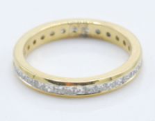 An 18ct gold ring set with a round cut diamond of