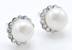 A pair of ladies silver stud earrings set with whi