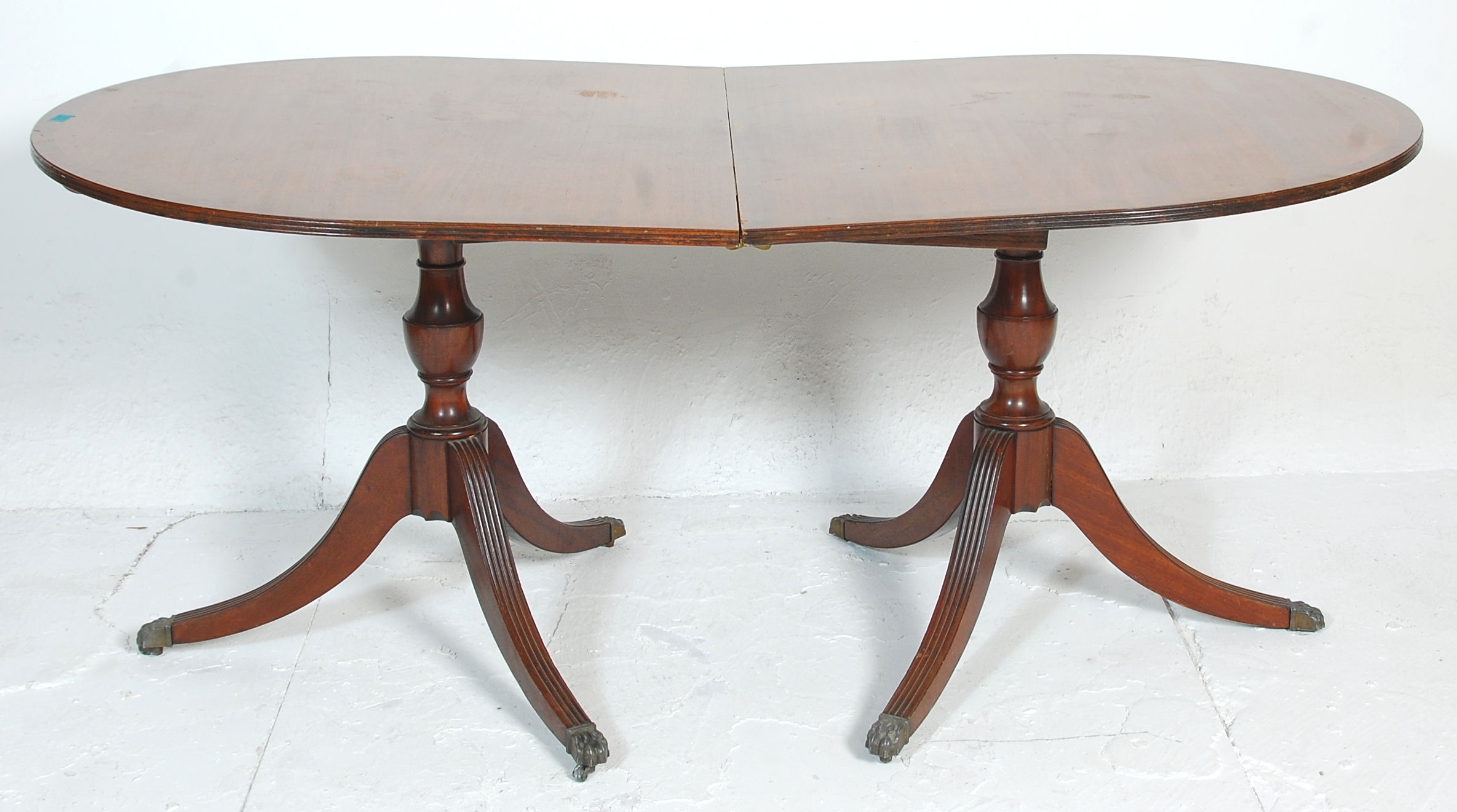 An antique mahogany folding breakfast table having
