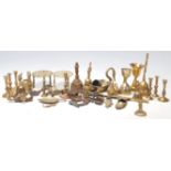 A good collection of miniature brass candlestick, brass trivets with pierced top, brass table bells,