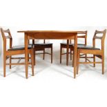 A vintage retro 20th century teak wood circular extending dining table with four chairs, having