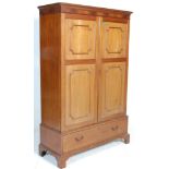 An Edwardian early 20th Century mahogany double wardrobe with panel doors to the double wardrobe