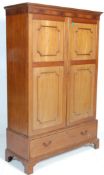 An Edwardian early 20th Century mahogany double wardrobe with panel doors to the double wardrobe