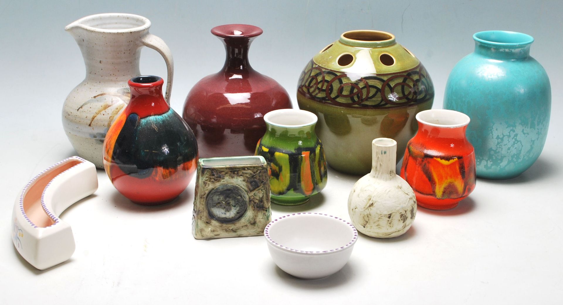 A collection of retro 20th Century studio art Poole pottery to include ceramic green glazed vase
