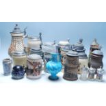 A large collection of German blue and grey stoneware jugs and beer steins, some having pewter