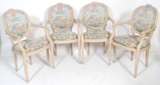 A set of four style 20th century French Fauteuil dining chairs / carver armchairs. Each with hand