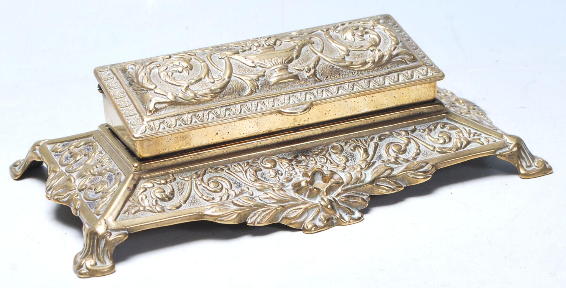 A late 19th century Victorian desk top brass inkwell
