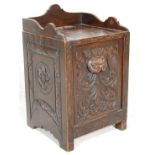 A 19th Century Victorian carved oak coal scuttle purdonium having a gallery top with a fall front