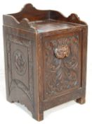 A 19th Century Victorian carved oak coal scuttle purdonium having a gallery top with a fall front