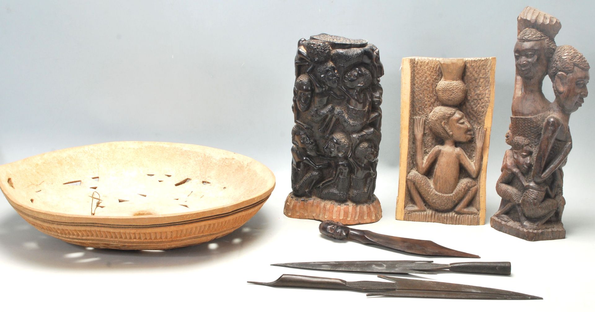 A collection of vintage African tribal artefacts to include a pair of tribal spearheads, an ebony