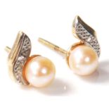 A pair of 20th Century pearl and diamond earrings set on gold posts. Comes boxed. Weighs 1g,
