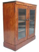 A 19th Century Victorian mahogany pier cabinet / bookcase with a ribbed glass double door having a