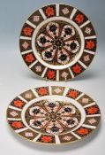 A pair of 20th Century Royal Crown Derby Imari plates having red, blue and gilt patterned
