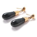 A pair of ladies 14ct gold drop earrings being set with polished green hard stone drops. Earring