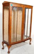 A 20th Century, circa 1940's Queen Anne style walnut china display cabinet vitrine having a