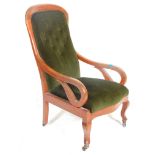 A Victorian 19th Century button back arm chair / library chair upholstered in green velour button