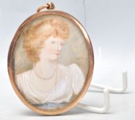 An early 20th Century Edwardian portrait miniature on ivory set with in a gilt oval frame ebing hand