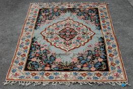 A 20th Century crewel work embroidery wall hanging having a floral bordered design around a