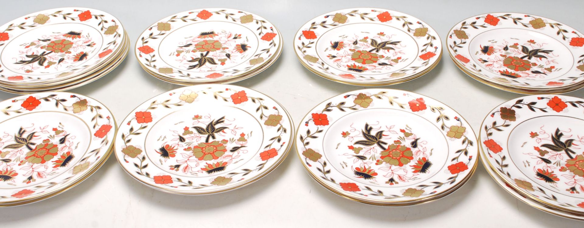 A group of vintage Royal Crown Derby Asian Rose pattern plates each being decorated with red and