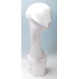 A contemporary abstract shop haberdashery, -advertising tabletop mannequin head finished in white of