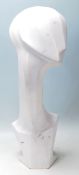 A contemporary abstract shop haberdashery, -advertising tabletop mannequin head finished in white of