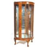 A 1930's art deco walnut veneered china display cabinet / vitrine. Raised on cabriole legs with