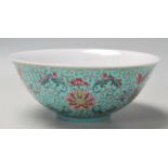 A vintage 20th Century Chinese bowl decorated with floral, butterfly and Shou emblem designs on a