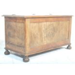 An early 20th Century oak blanket box chest / coffer having a flared and hinged top over crested