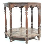 A 19th Century Victorian oak centre table of octagonal form having a carved table top over six