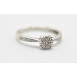 A 9ct white gold ladies dress ring having a diamond cluster in a cathedral setting and further