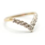 A hallmarked 9ct gold wishbone ring being illusion set with round cut white accent stones.
