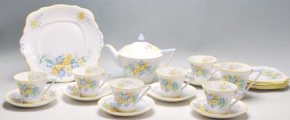 A vintage 1930's Bell china Art Deco tea service decorated with a printed yellow and blue pattern